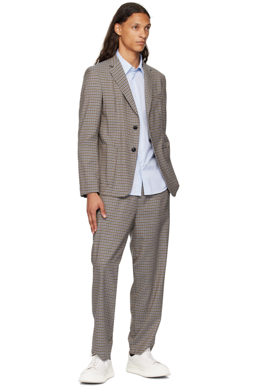 Stretch polyester -and virgin wool-blend Prince of Wales blazer.

· Notched lapel
· Button closure
· Patch pockets
· Four-button surgeon cuffs
· Twin vents at back hem
· Partial logo-woven twill lining

Supplier color: Unico