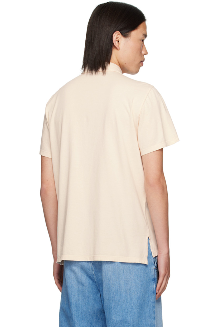 Garment-dyed cotton jersey polo. 

· Spread collar
· Three-button placket 
· Patch pocket 
· Tennis-tail hem 
· Logo flag at side seam

Supplier color: Cristal