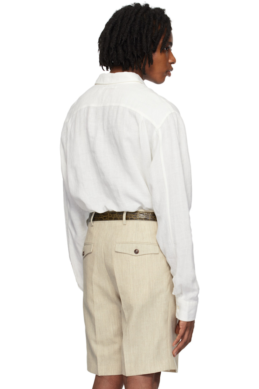 Plain-woven linen shirt. Jacquard stripes throughout.

· Spread collar
· Three-button placket
· Patch pocket
· Embroidered detailing at side seam
· Pleat at single-button barrel cuffs
· Locker loop at back yoke

Supplier color: Thasos beach