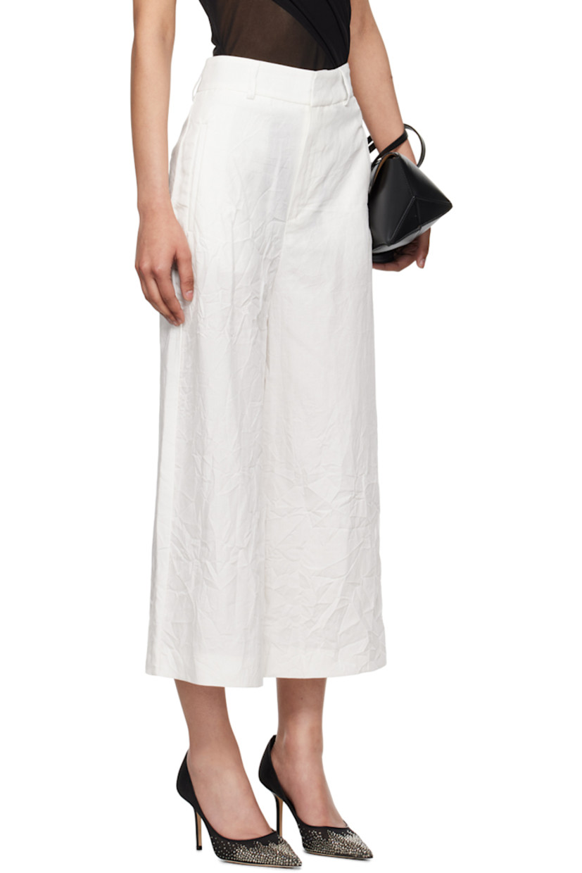 Crinkled TENCEL™ lyocell- and linen-blend canvas trousers.

· Belt loops
· Four-pocket styling
· Zip-fly

Supplier color: White