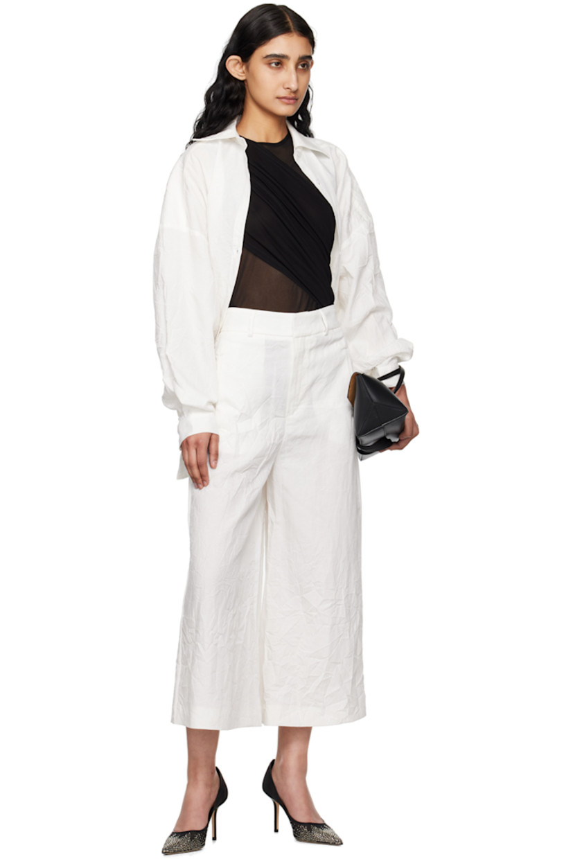 Crinkled TENCEL™ lyocell- and linen-blend canvas trousers.

· Belt loops
· Four-pocket styling
· Zip-fly

Supplier color: White