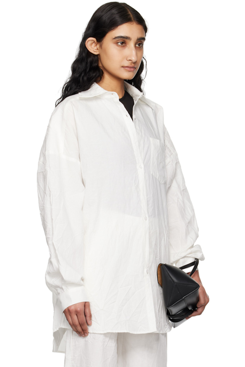 Crinkled TENCEL™ lyocell- and linen-blend canvas shirt. 

· Spread collar
· Button closure
· Patch pocket
· Shirttail hem
· Dropped shoulders
· Single-button barrel cuffs
· Twin pleats at back yoke

Supplier color: White