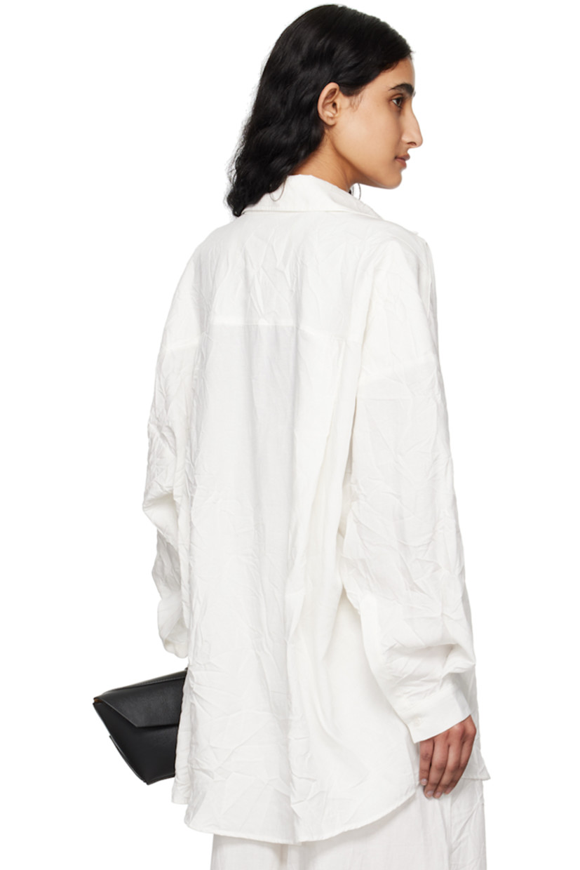 Crinkled TENCEL™ lyocell- and linen-blend canvas shirt. 

· Spread collar
· Button closure
· Patch pocket
· Shirttail hem
· Dropped shoulders
· Single-button barrel cuffs
· Twin pleats at back yoke

Supplier color: White