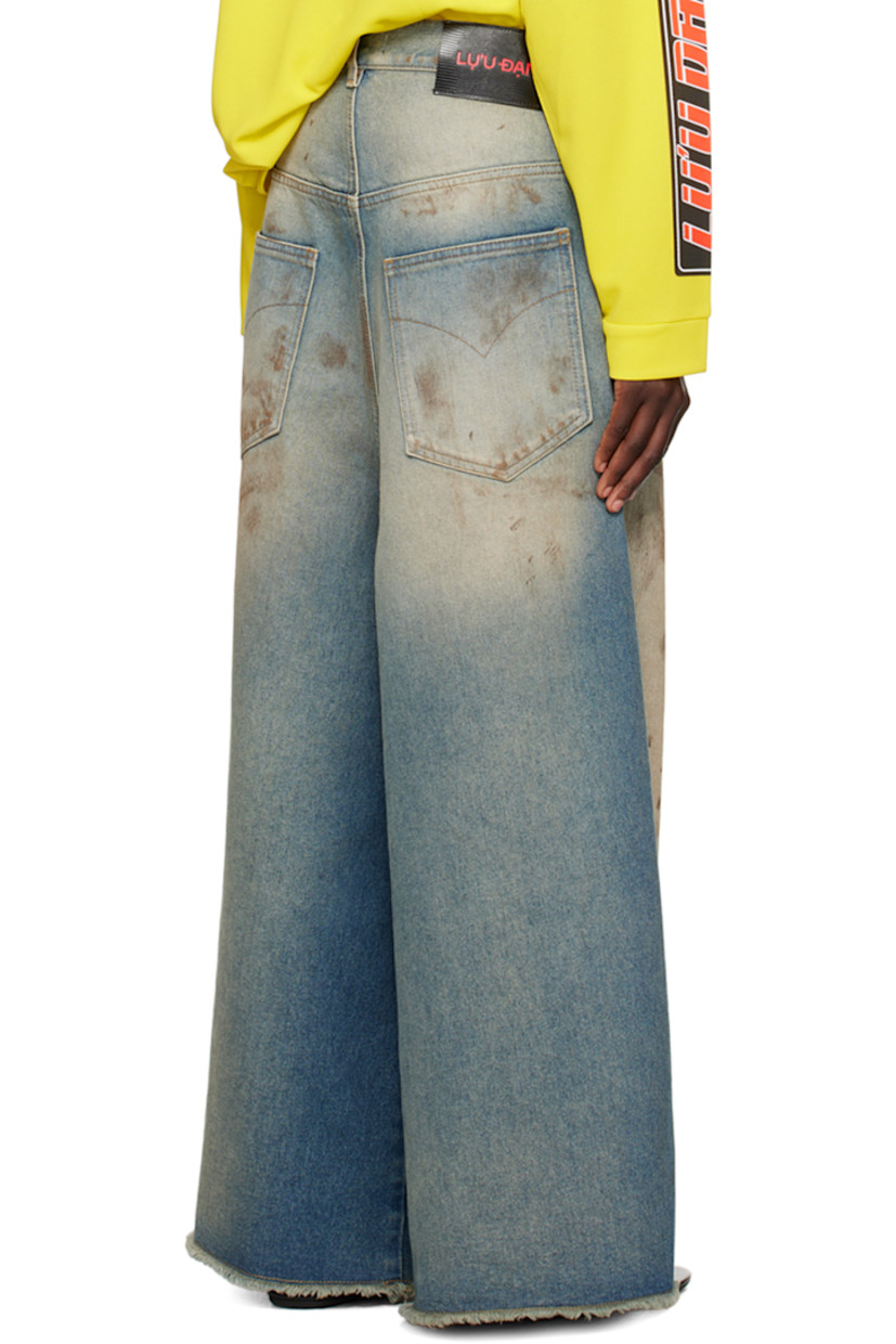 Wide-leg non-stretch denim jeans. Fading and smudging throughout.

· Belt loops
· Five-pocket styling
· Zip-fly
· Frayed edge at cropped legs
· Logo patch at back waistband
· Logo-engraved silver-tone hardware
 
Supplier color: Stained blue