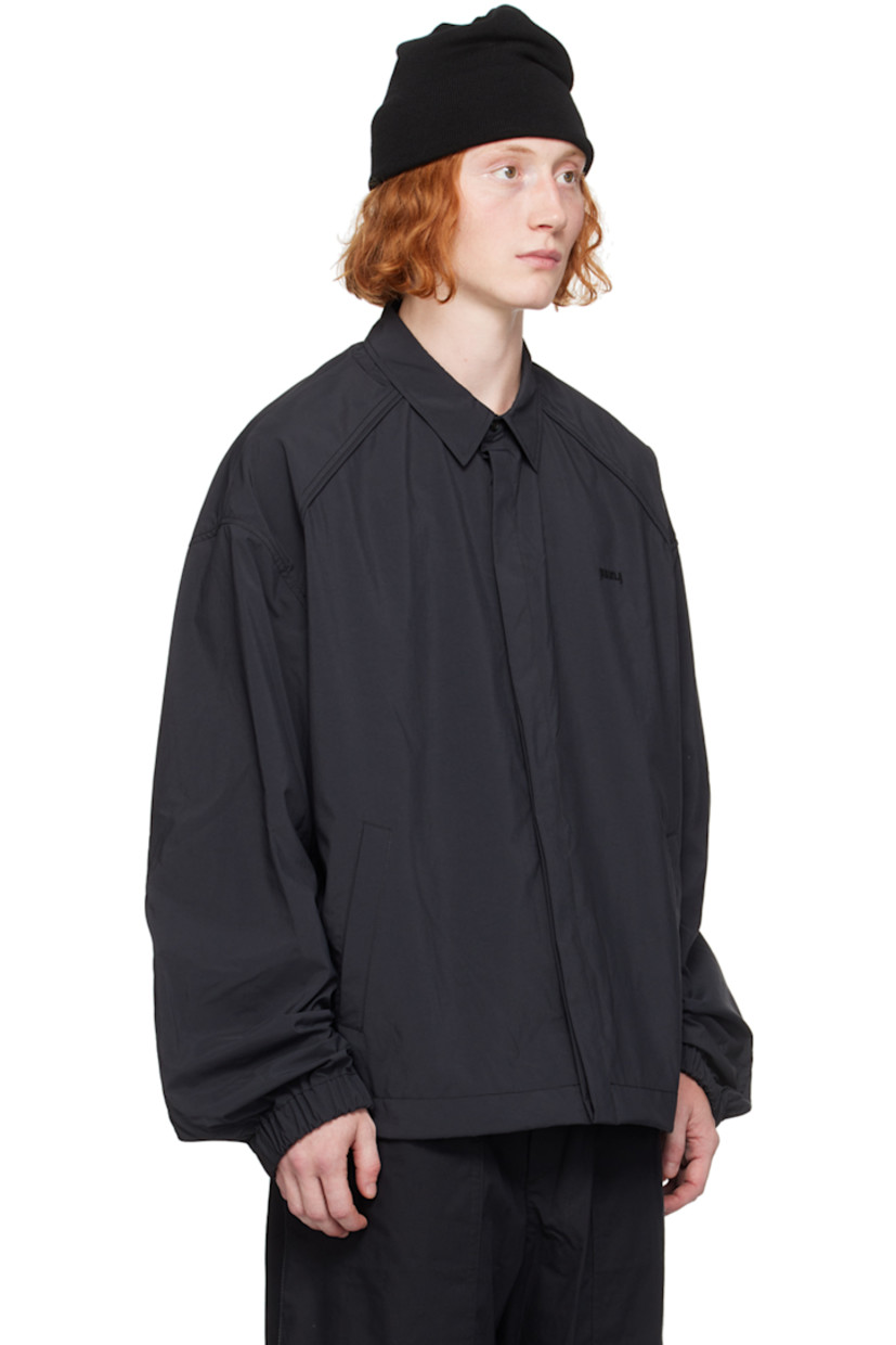 Loose-fit polyester poplin shirt.

· Spread collar
· Concealed button closure
· Logo embroidered at chest
· Welt pockets
· Bungee-style drawstring at hem 
· Piping at raglan sleeves
· Elasticized cuffs
· Central seam at back

Supplier color: Black