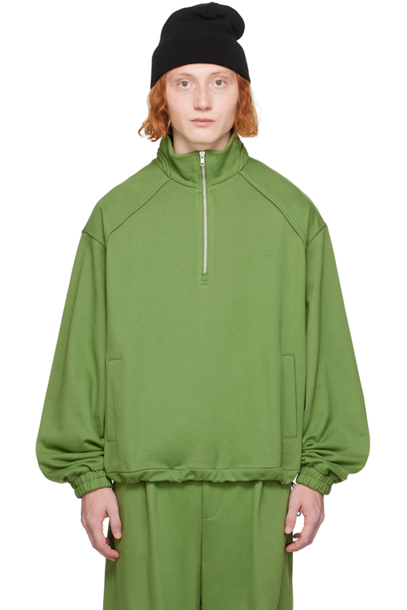 French terry sweater.

· Mock neck
· Quarter-zip closure
· Logo embroidered at chest
· Welt pockets
· Bungee-style drawstring at hem
· Raglan sleeves 
· Elasticized cuffs

Supplier color: Olive
