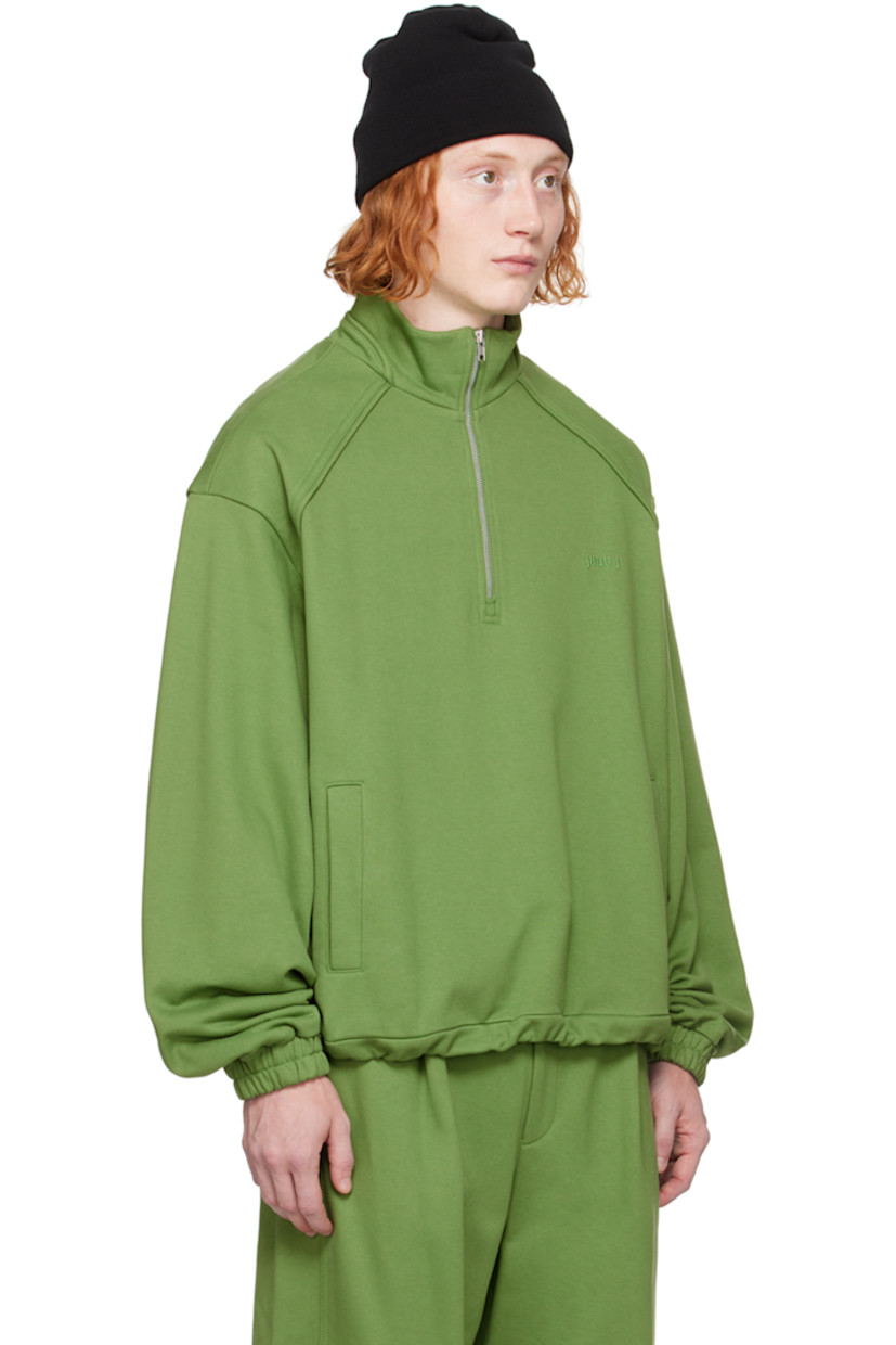 French terry sweater.

· Mock neck
· Quarter-zip closure
· Logo embroidered at chest
· Welt pockets
· Bungee-style drawstring at hem
· Raglan sleeves 
· Elasticized cuffs

Supplier color: Olive