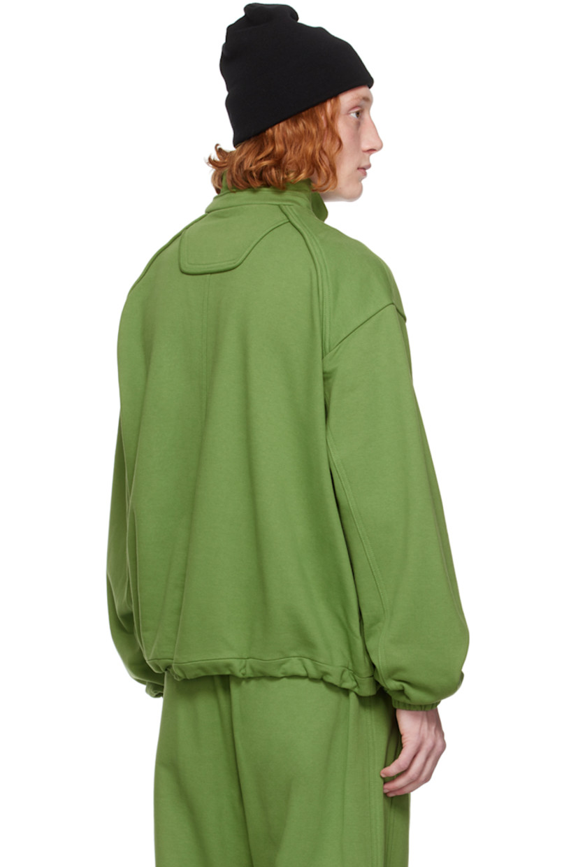 French terry sweater.

· Mock neck
· Quarter-zip closure
· Logo embroidered at chest
· Welt pockets
· Bungee-style drawstring at hem
· Raglan sleeves 
· Elasticized cuffs

Supplier color: Olive