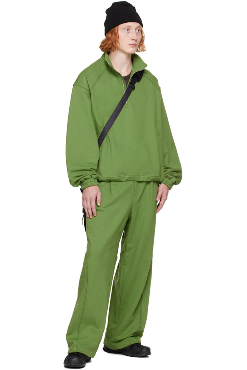 French terry sweater.

· Mock neck
· Quarter-zip closure
· Logo embroidered at chest
· Welt pockets
· Bungee-style drawstring at hem
· Raglan sleeves 
· Elasticized cuffs

Supplier color: Olive