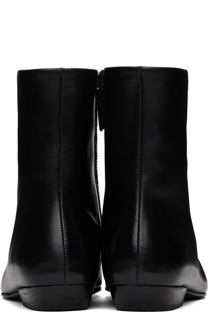 Ankle-high buffed leather boots in black.

· Zip closure at inner side
· Grained leather lining
· Stacked leather heel with rubber injection
· Leather sole

Supplier color: Black
