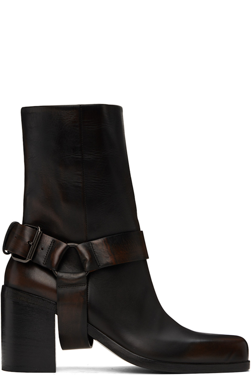 Ankle-high waxed leather boots in black.

· Fading throughout
· Square toe
· Detachable stirrup-style pin-buckle ankle strap
· Concealed pull-loop at collar
· Grained leather lining
· Stacked leather block heel with rubber injection
· Polished leather sole
· Heel: H3"

Supplier color: Black