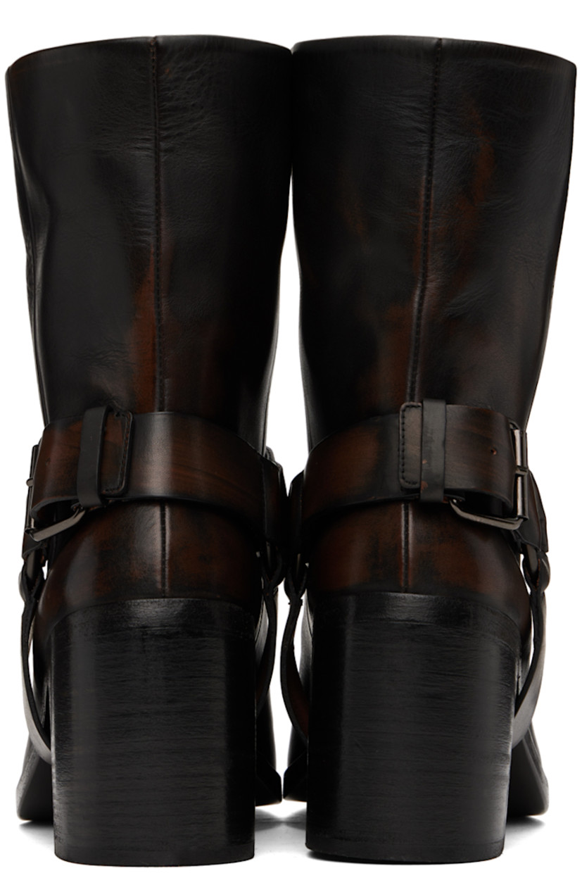 Ankle-high waxed leather boots in black.

· Fading throughout
· Square toe
· Detachable stirrup-style pin-buckle ankle strap
· Concealed pull-loop at collar
· Grained leather lining
· Stacked leather block heel with rubber injection
· Polished leather sole
· Heel: H3"

Supplier color: Black