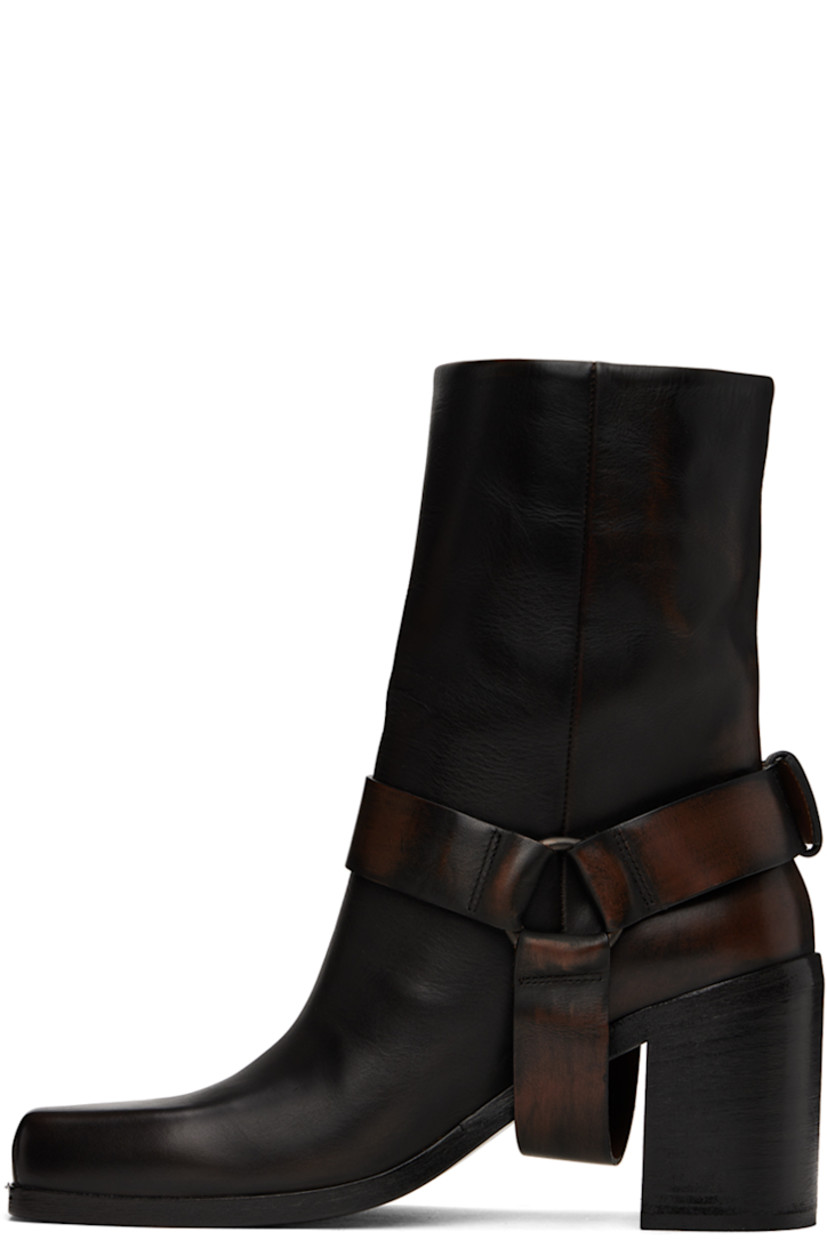 Ankle-high waxed leather boots in black.

· Fading throughout
· Square toe
· Detachable stirrup-style pin-buckle ankle strap
· Concealed pull-loop at collar
· Grained leather lining
· Stacked leather block heel with rubber injection
· Polished leather sole
· Heel: H3"

Supplier color: Black