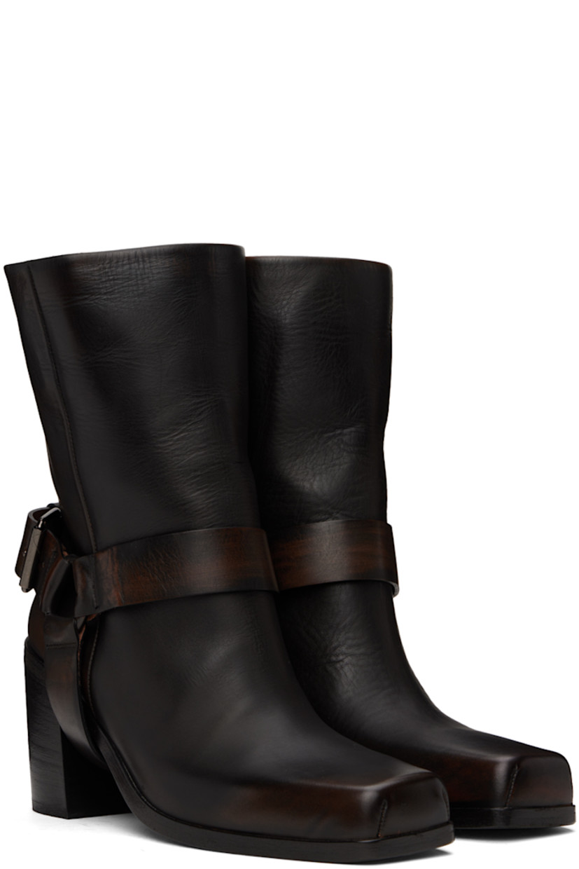 Ankle-high waxed leather boots in black.

· Fading throughout
· Square toe
· Detachable stirrup-style pin-buckle ankle strap
· Concealed pull-loop at collar
· Grained leather lining
· Stacked leather block heel with rubber injection
· Polished leather sole
· Heel: H3"

Supplier color: Black