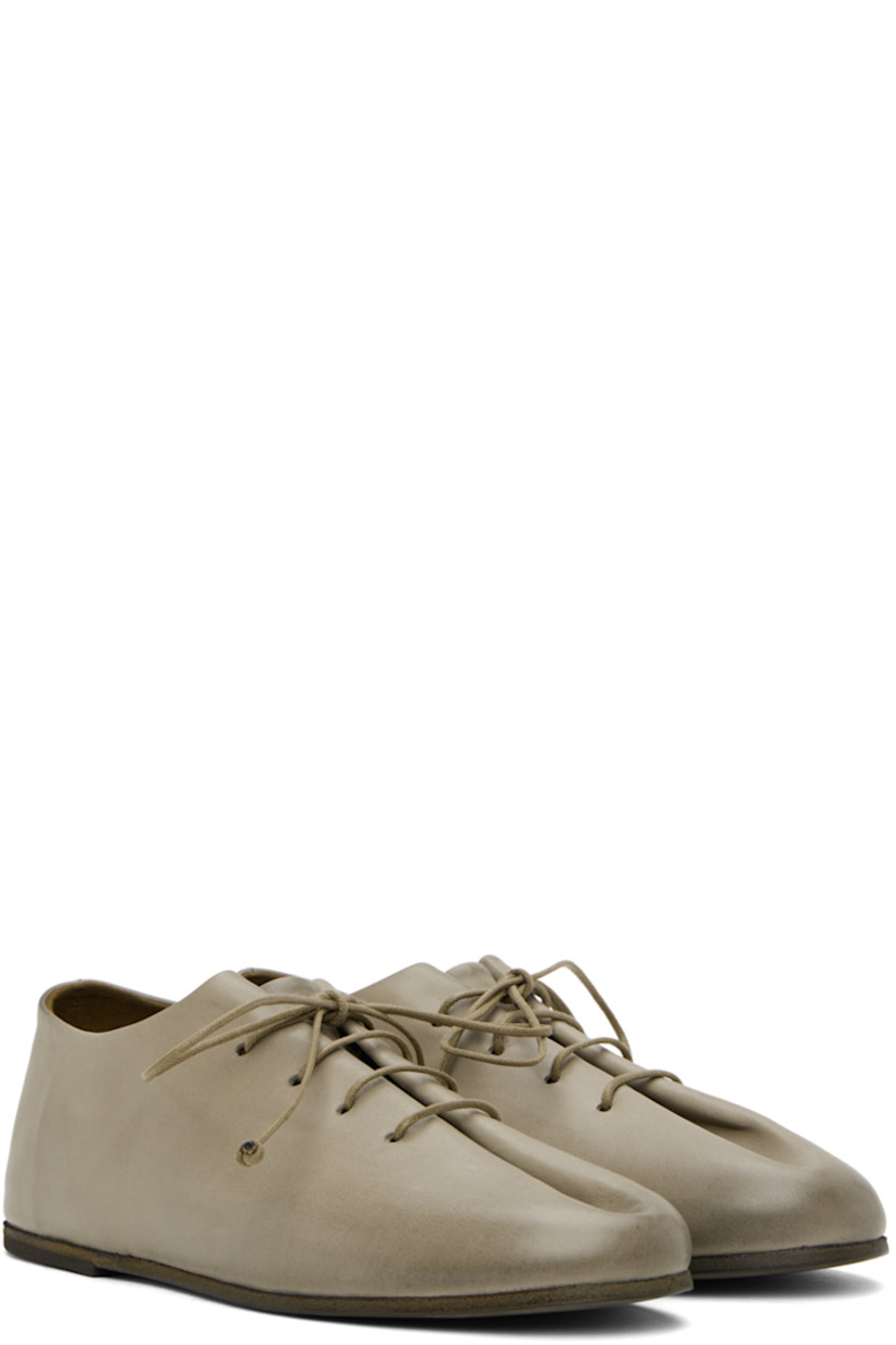 Buffed calfskin derbys in gray.

· Lace-up closure
· Pleats at vamp
· Buffed leather and nubuck lining
· Hand-colored leather sole with rubber injection

Supplier color: Clay