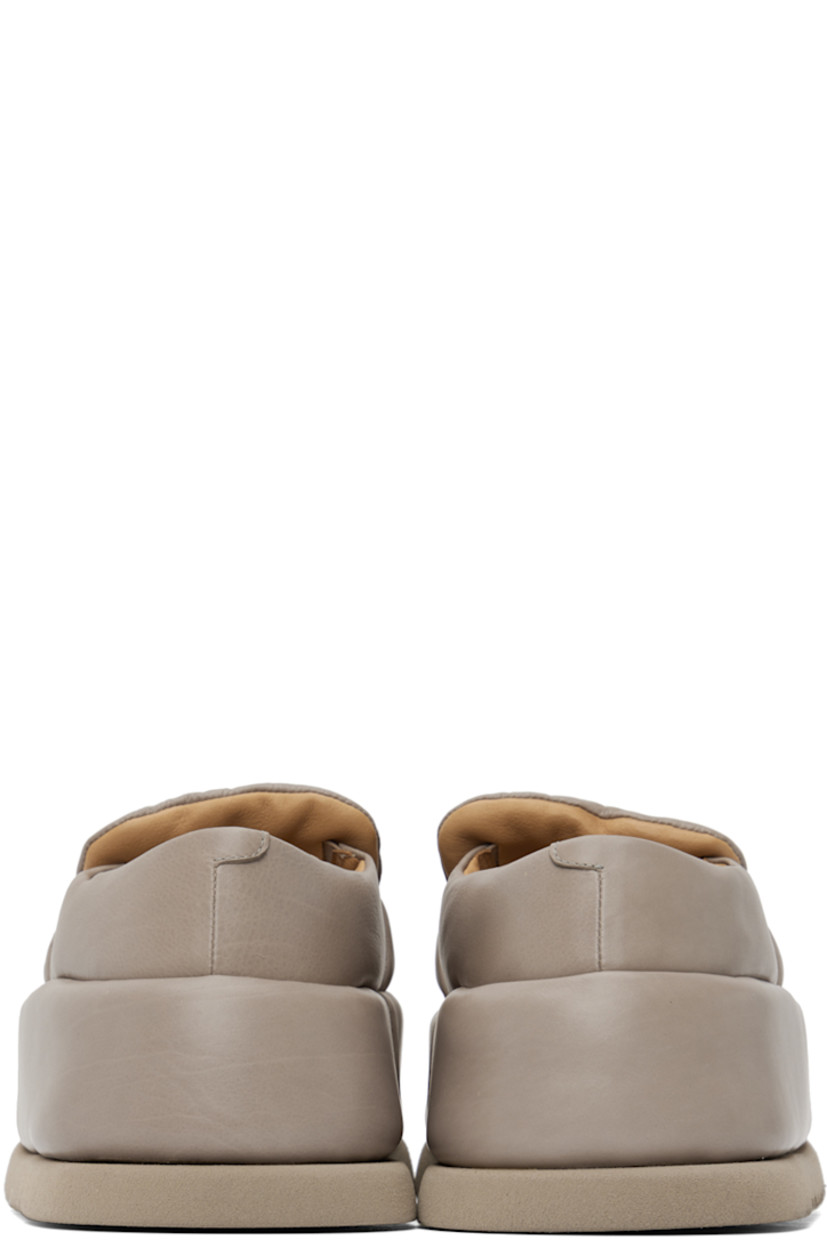 Handcrafted padded buffed calfskin loafers in taupe.

· Moc toe
· Strap at vamp
· Logo embossed at leather footbed
· Buffed leather and suede lining 
· Covered platform midsole
· Treaded foam rubber sole 
· Platform: H2.5"

Supplier color: Clay