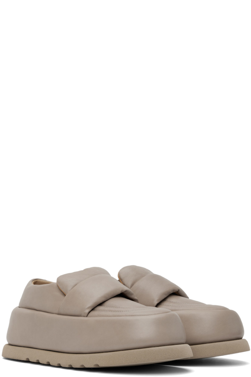 Handcrafted padded buffed calfskin loafers in taupe.

· Moc toe
· Strap at vamp
· Logo embossed at leather footbed
· Buffed leather and suede lining 
· Covered platform midsole
· Treaded foam rubber sole 
· Platform: H2.5"

Supplier color: Clay