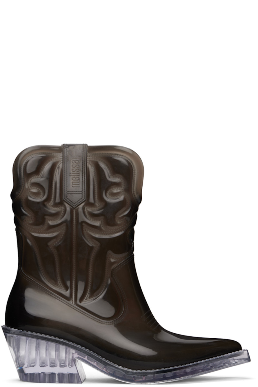Ankle-high semi-transparent and lightweight PVC boots in black.

· Quilted detailing throughout
· Pointed toe
· Logo embossed at sides
· Grenflex insole
· Rubber block heel
· Treaded rubber sole
· Heel: H2.25"

Supplier color: Black