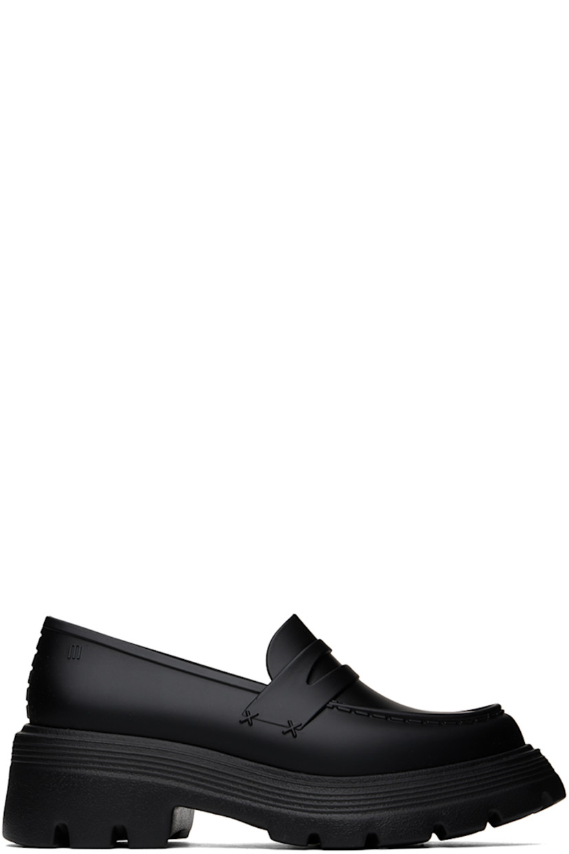 Melflex® PVC loafers in black.

· Moc toe
· Strap at vamp
· Logo embossed at outer side
· Eyelets at inner side
· Padded faux-leather footbed
· Textured rubber block heel
· Treaded rubber sole
· Heel: H2"

Supplier color: Black
