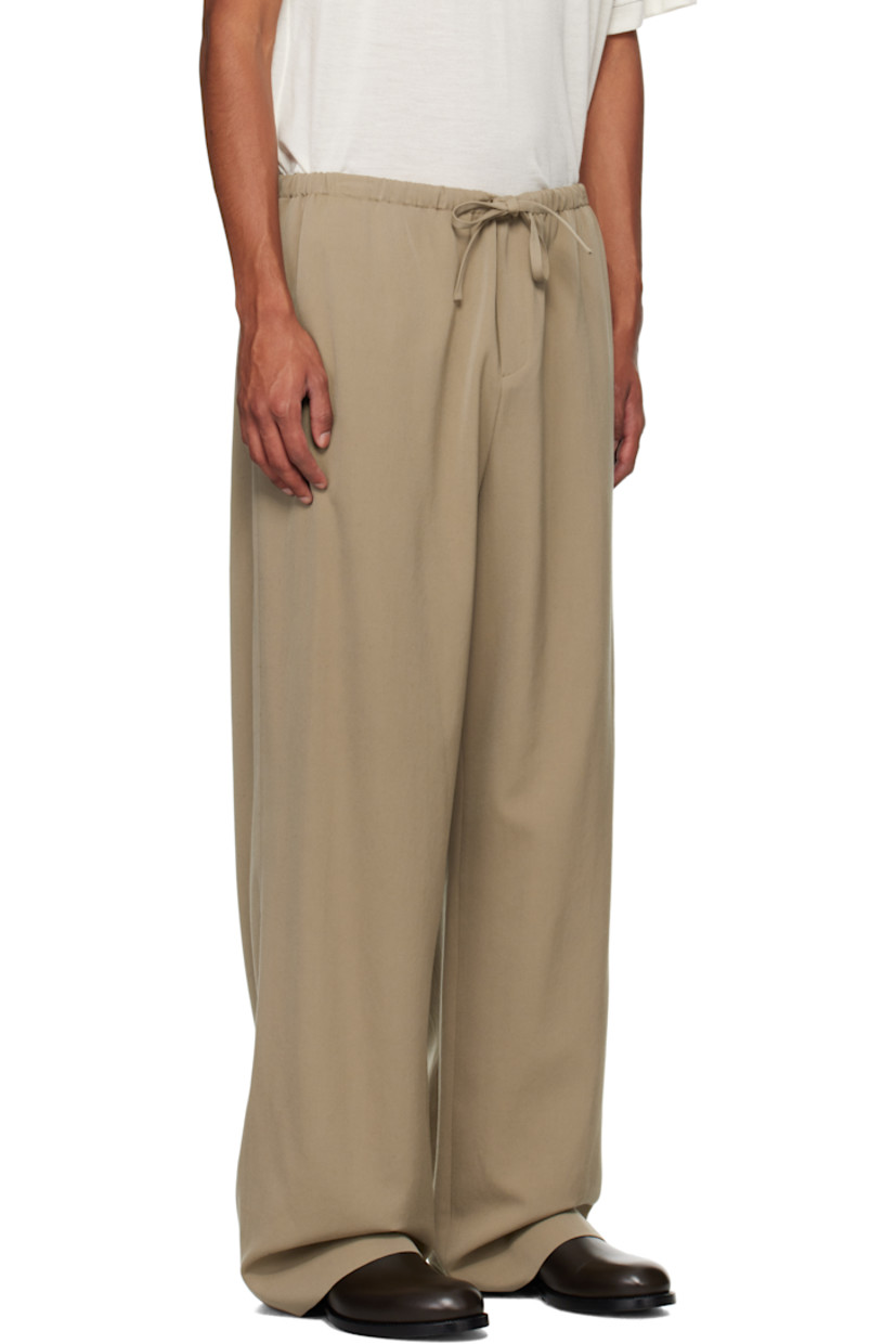 Wool grain de poudre trousers.

· Mid-rise
· Drawstring at elasticized waistband
· Three-pocket styling
· Zip-fly

Supplier color: Grey taupe
