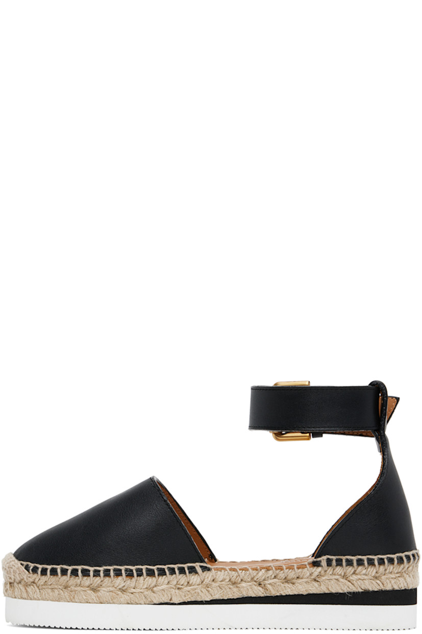 Grained calfskin espadrilles in black.

· Pin-buckle ankle strap
· Logo embossed at heel tab
· Logo embossed at padded leather footbed
· Suede and buffed leather lining
· Blanket stitching at welt
· Braided jute midsole
· Treaded foam rubber platform sole
· Platform: H1.25"

Supplier color: Black