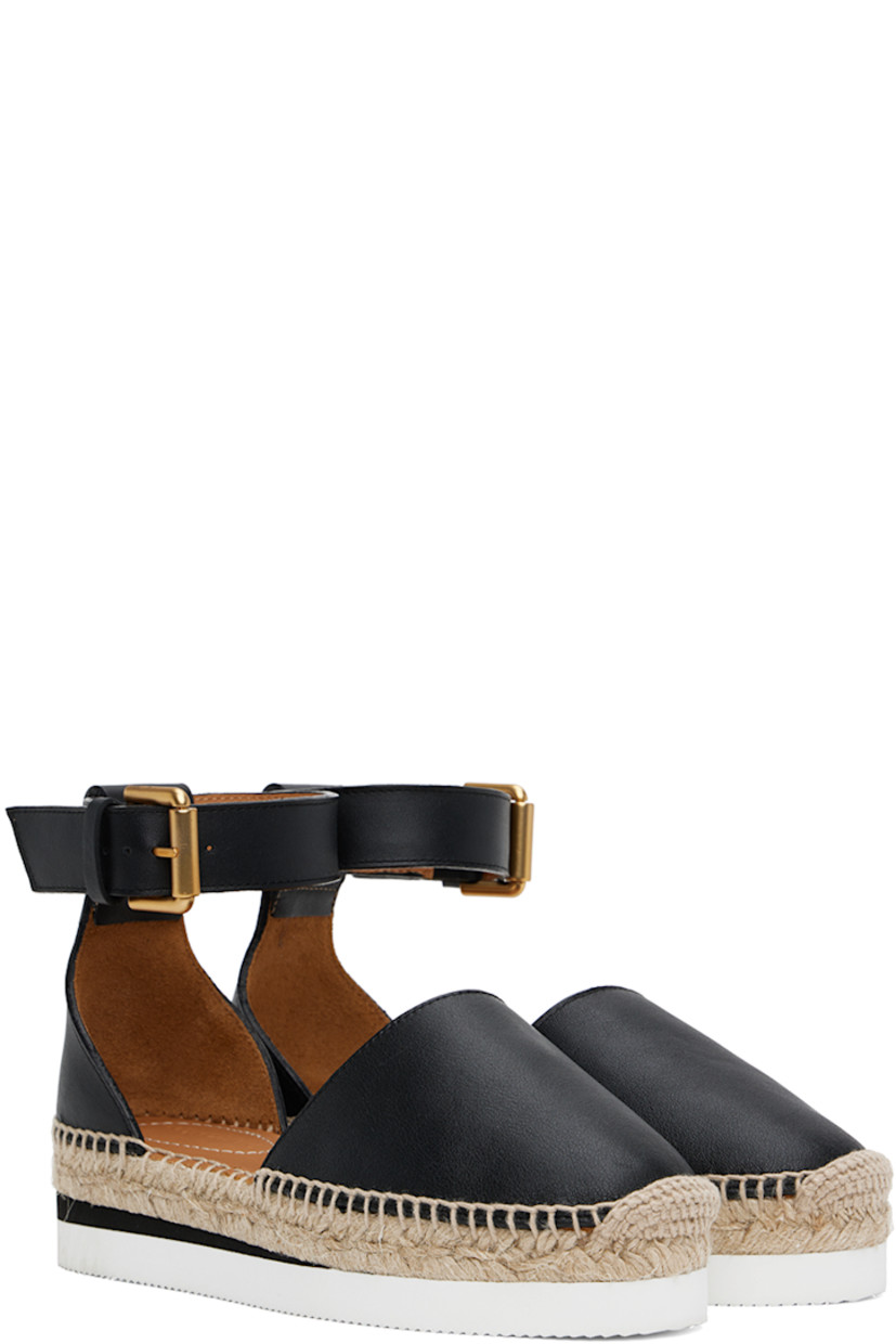 Grained calfskin espadrilles in black.

· Pin-buckle ankle strap
· Logo embossed at heel tab
· Logo embossed at padded leather footbed
· Suede and buffed leather lining
· Blanket stitching at welt
· Braided jute midsole
· Treaded foam rubber platform sole
· Platform: H1.25"

Supplier color: Black
