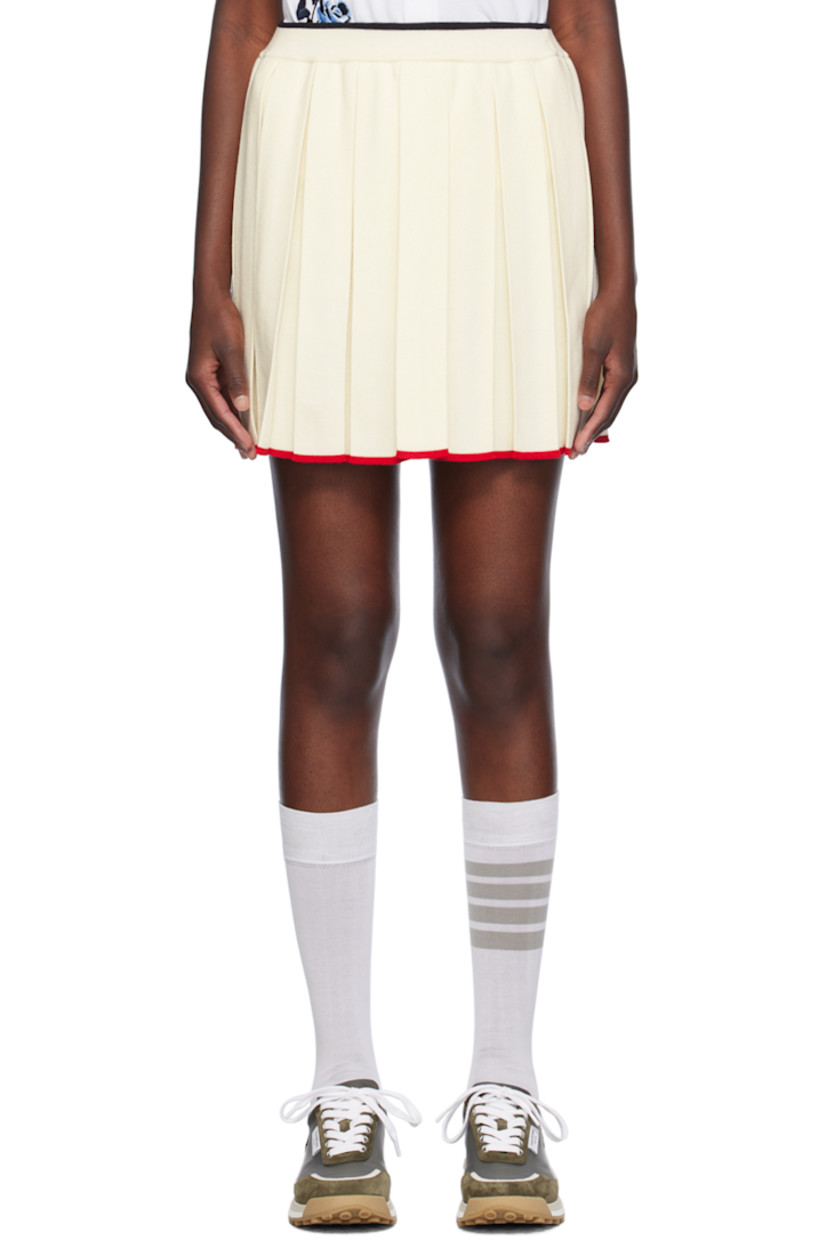 Knit virgin wool-blend skirt. Box pleats throughout.

· Rib knit elasticized waistband
· Stripe at waistband and hem
· Tricolor grosgrain flag at back waistband 

Supplier color: White