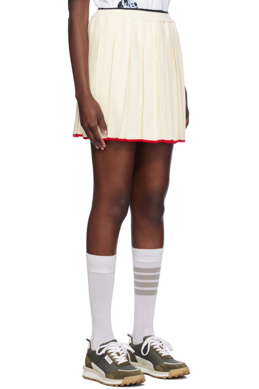 Knit virgin wool-blend skirt. Box pleats throughout.

· Rib knit elasticized waistband
· Stripe at waistband and hem
· Tricolor grosgrain flag at back waistband 

Supplier color: White