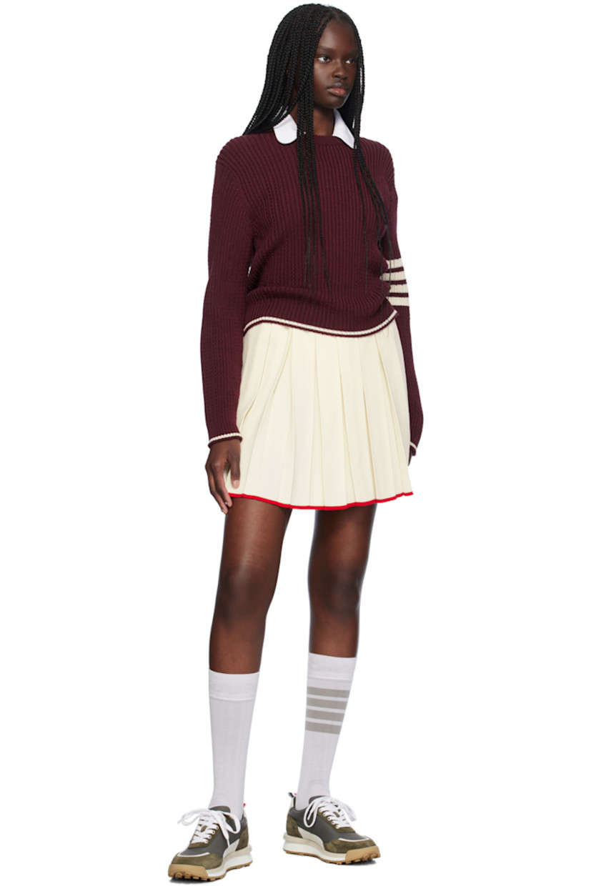 Knit virgin wool-blend skirt. Box pleats throughout.

· Rib knit elasticized waistband
· Stripe at waistband and hem
· Tricolor grosgrain flag at back waistband 

Supplier color: White