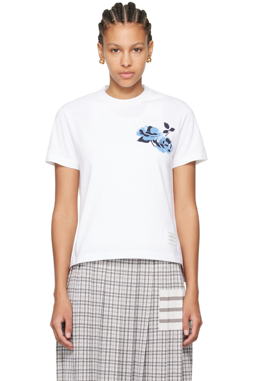 Stretch cotton jersey T-shirt. 

· Rib knit crewneck
· Floral graphic printed at chest 
· Logo patch at front hem
· Droptail hem 
· Vented side seams
· Tricolor grosgrain flag at back collar

Supplier color: White