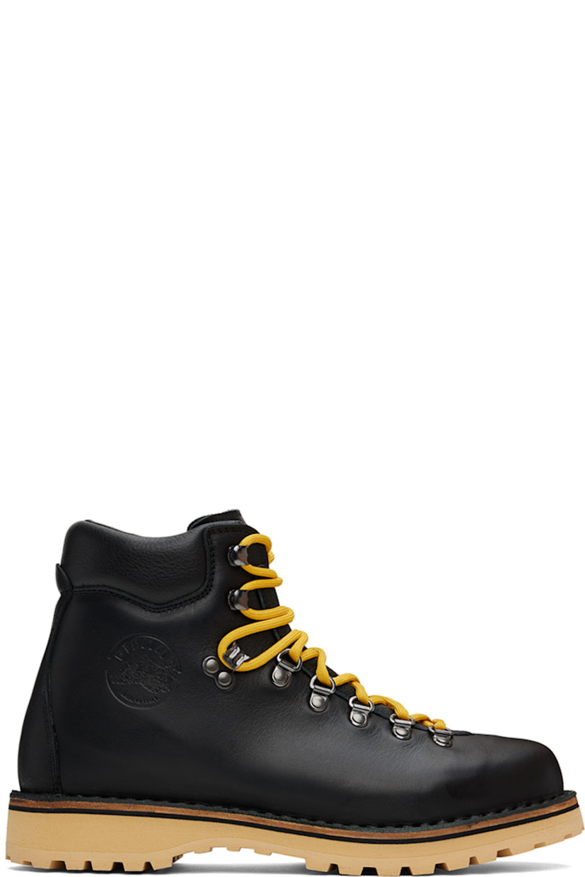 Ankle-high grained leather boots in black.

· Lace-up closure
· Logo embossed at padded tongue
· Padded collar
· Logo graphic embossed at outer side
· Nappa leather lining
· Topstitching at welt 
· Foam rubber midsole
· Lugged rubber sole
· Heel: H1.25"

Supplier color: Black leather