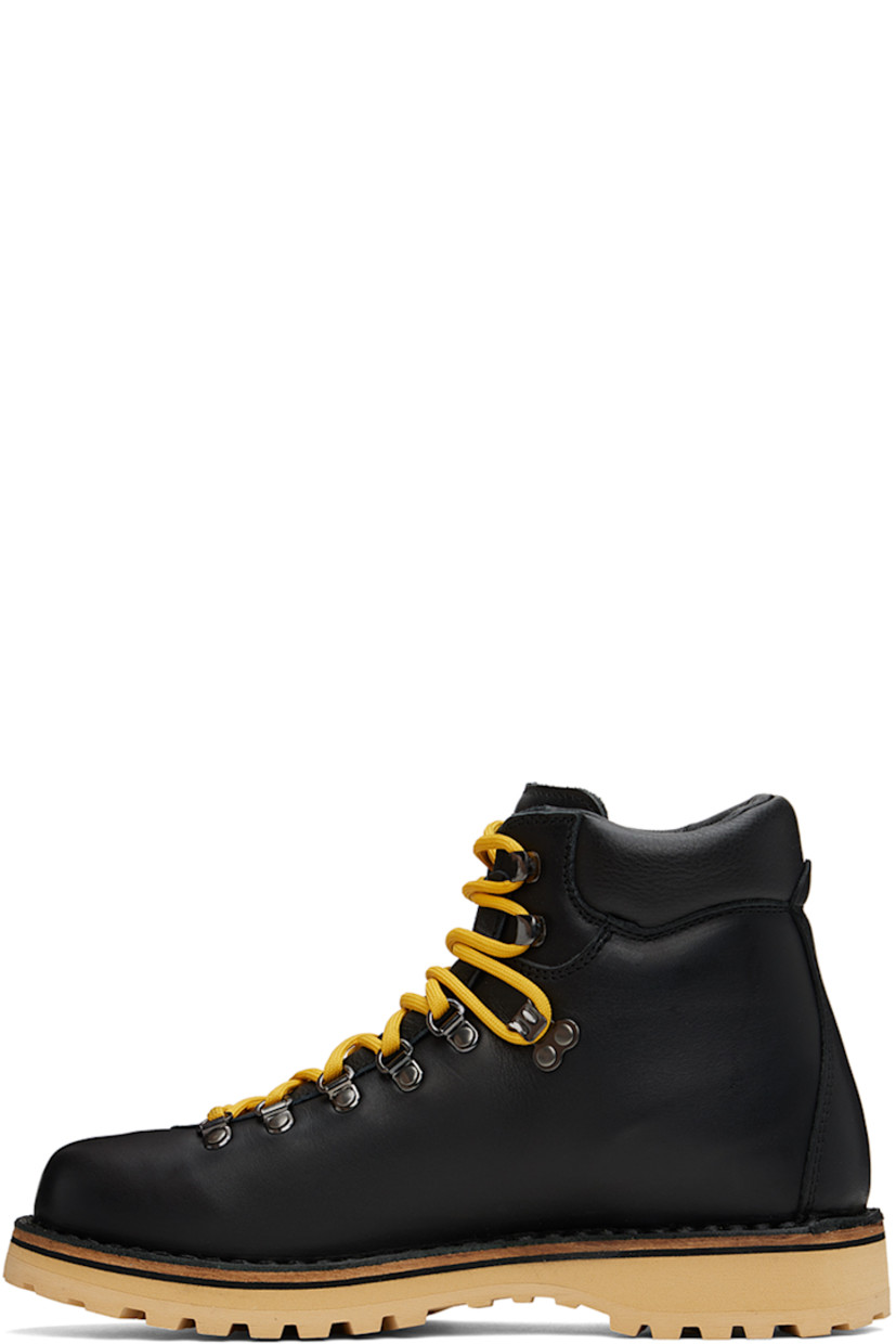 Ankle-high grained leather boots in black.

· Lace-up closure
· Logo embossed at padded tongue
· Padded collar
· Logo graphic embossed at outer side
· Nappa leather lining
· Topstitching at welt 
· Foam rubber midsole
· Lugged rubber sole
· Heel: H1.25"

Supplier color: Black leather