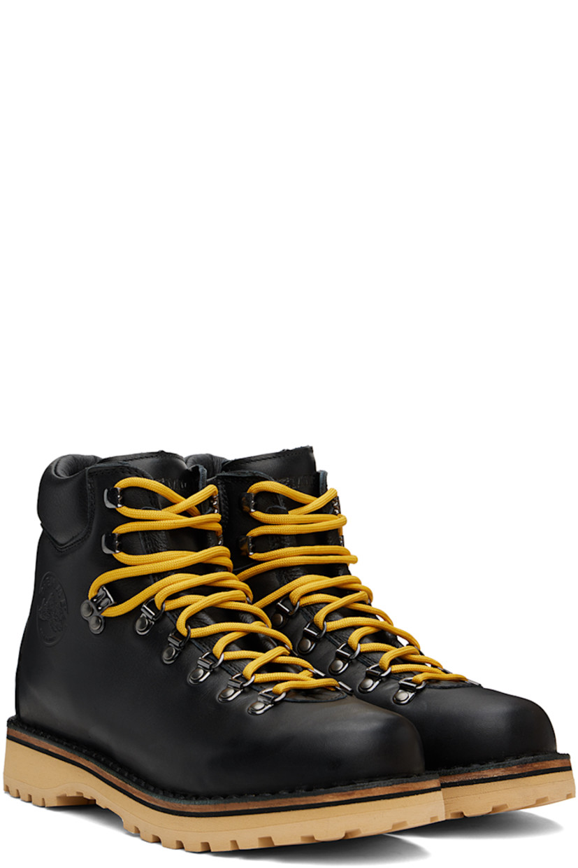 Ankle-high grained leather boots in black.

· Lace-up closure
· Logo embossed at padded tongue
· Padded collar
· Logo graphic embossed at outer side
· Nappa leather lining
· Topstitching at welt 
· Foam rubber midsole
· Lugged rubber sole
· Heel: H1.25"

Supplier color: Black leather