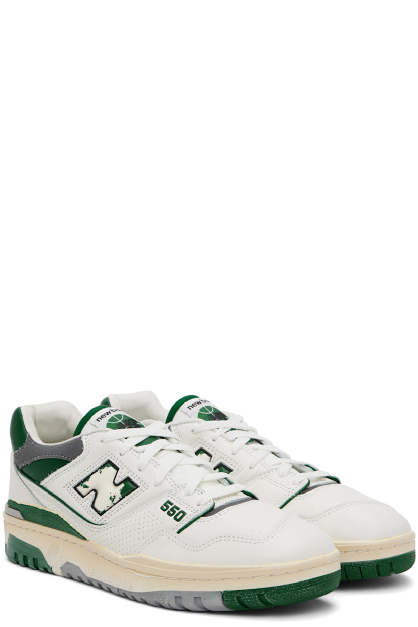 Low-top buffed leather sneakers in off-white, green, and gray.

· Perforated detailing at toe and sides
· Lace-up closure
· Logo patch at padded tongue
· Padded collar
· Distressed inset logo at sides
· Logo bonded at heel counter
· Grained leather and mesh lining
· Logo embossed at textured rubber midsole
· Treaded rubber sole

Supplier color: Sea salt/Marsh green/Shadow grey