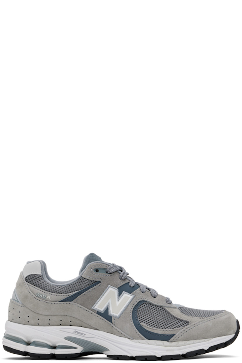Low-top pigskin suede and mesh sneakers in gray.

· Logo embroidered at vamp
· Lace-up closure
· Logo patch at padded tongue
· Padded collar
· Reflective logo appliqué at sides
· Perforated detailing at heel counter
· ABZORB® foam rubber midsole
· Treaded N-ergy rubber sole with Stability Web technology

Supplier color: Steel/Lead/Orca