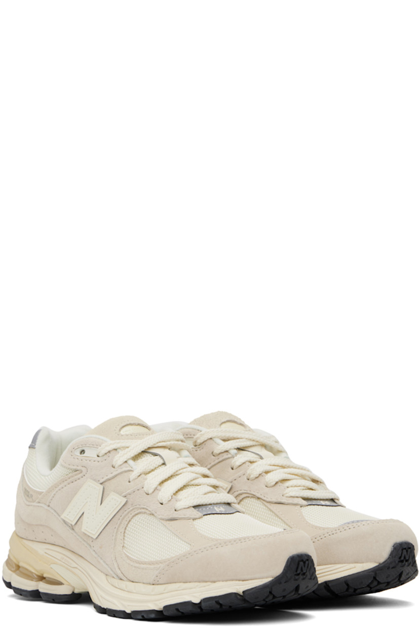 Low-top pigskin nubuck and mesh sneakers in taupe.

· Lace-up closure
· Rubberized logo patch at padded tongue
· Padded collar
· Perforated detailing at heel counter
· Logo appliqué at sides
· Jersey lining
· ABZORB® foam rubber midsole
· Stability Web technology
· Treaded N-ergy rubber sole

Supplier color: Calm taupe/Angora/Silver metallic