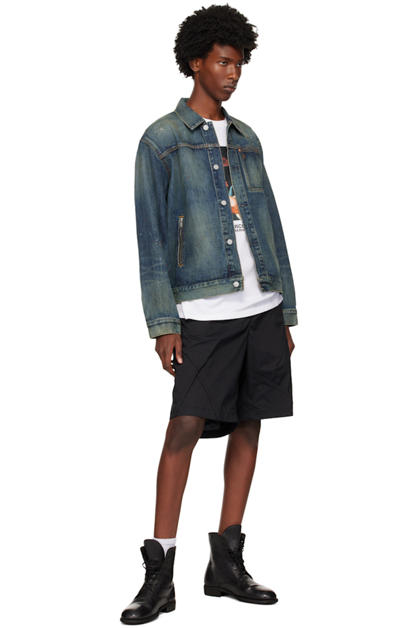 Non-stretch denim jacket. Fading, whiskering, and graphics embroidered throughout.

· Spread collar
· Button closure 
· Logo flag at chest
· Patch pocket and zip pockets
· Dropped shoulders
· Adjustable single-button barrel cuffs
· Adjustable button tabs at back hem
· Logo-engraved silver-tone hardware
· Contrast stitching in yellow

Supplier color: Light blue indigo