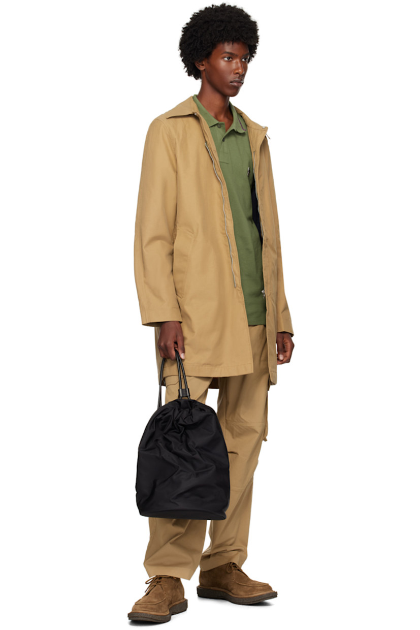 Cotton- and nylon- blend gabardine coat.

· Spread collar
· Concealed zip closure
· Welt pockets
· Logo patch at front
· Central vent at back hem
· Welt pocket at interior
· Partially lined

Supplier color: Brown