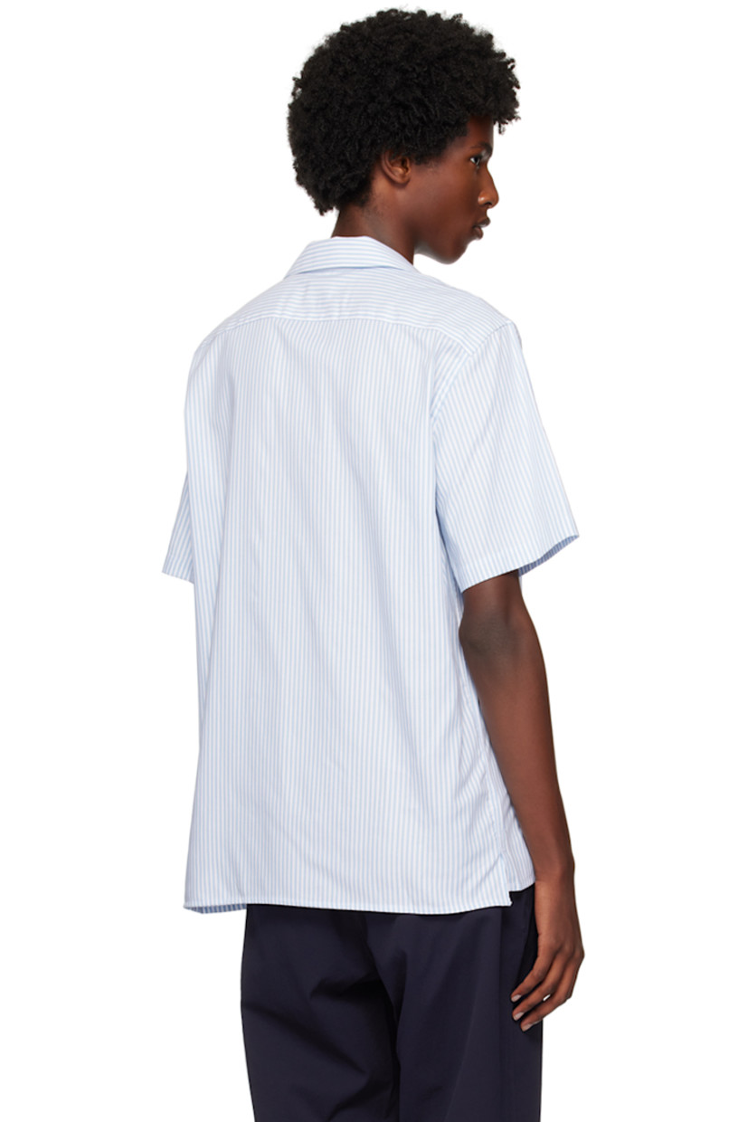 GOTS-certified organic cotton oxford cloth shirt.

· Open spread collar
· Button closure
· Embroidered appliqués at front
· Logo flag at side seam

Supplier color: Blues