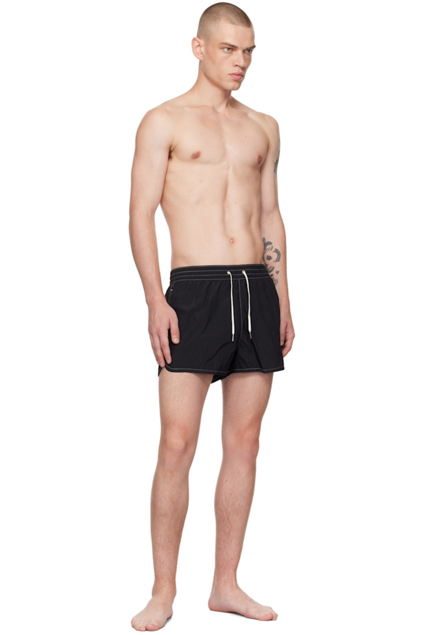 Quick-drying ECONYL® regenerated nylon twill swim shorts.

· Drawstring at elasticized waistband
· Three-pocket styling
· Engraved grommets at back waist
· Vented side seams
· Full mesh lining
· Contrast stitching in white

Supplier color: Black