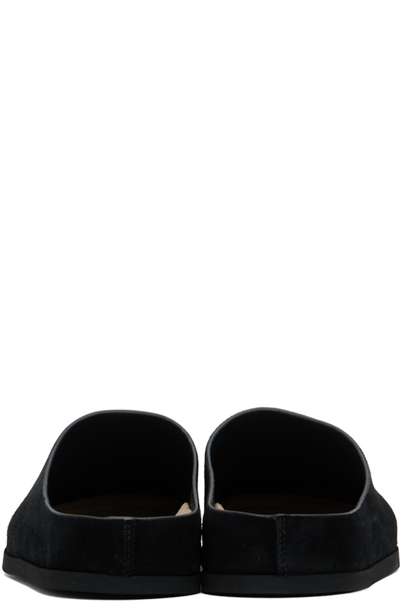 Suede slip-on loafers in black. 

· Signature series embossed at outer side
· Logo stamp at molded suede footbed
· Buffed leather lining
· Rubber sole

Supplier color: Black