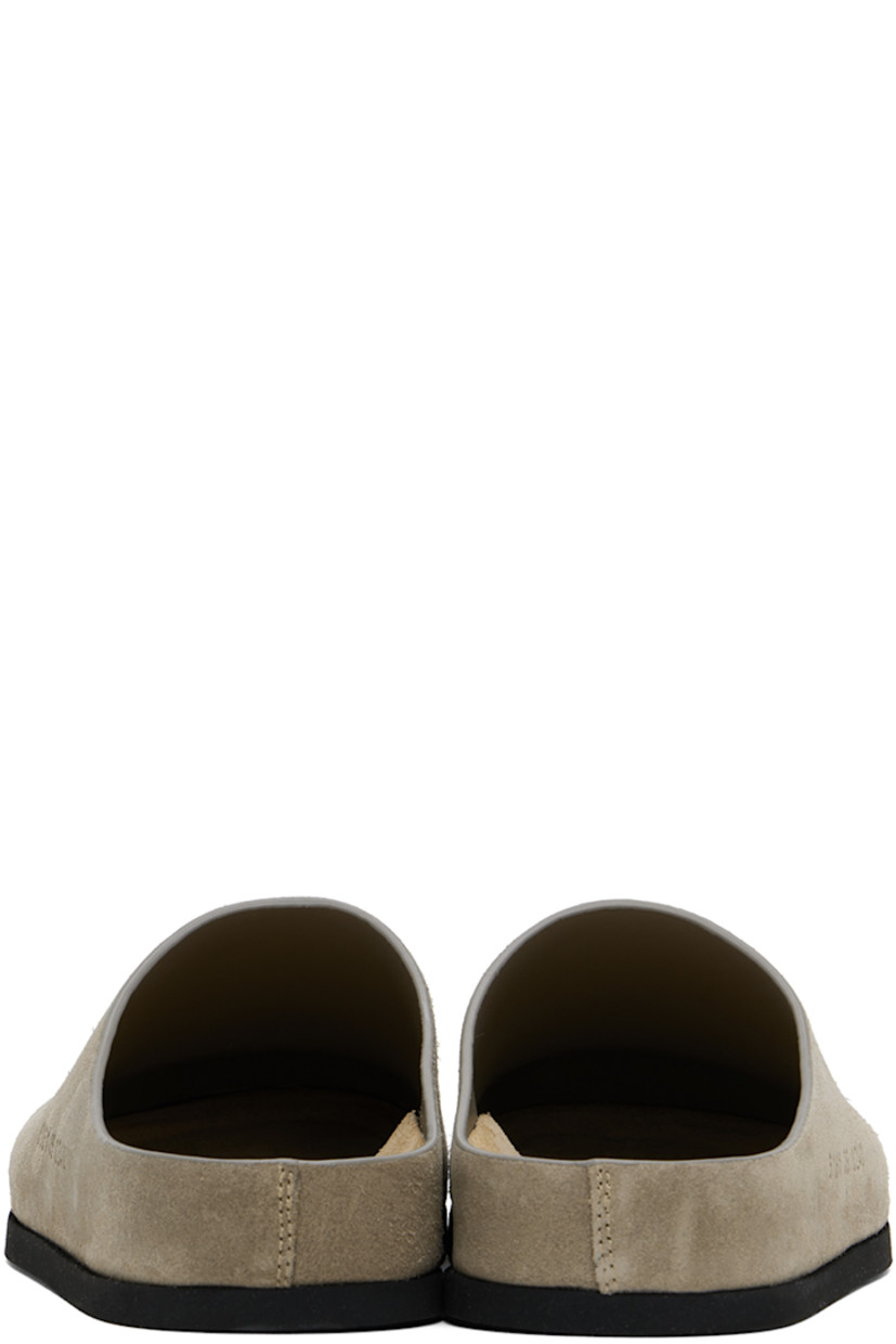 Suede slip-on loafers in taupe.

· Signature series embossed at outer side
· Logo stamp at molded suede footbed
· Buffed leather lining
· Rubber sole

Supplier color: Taupe