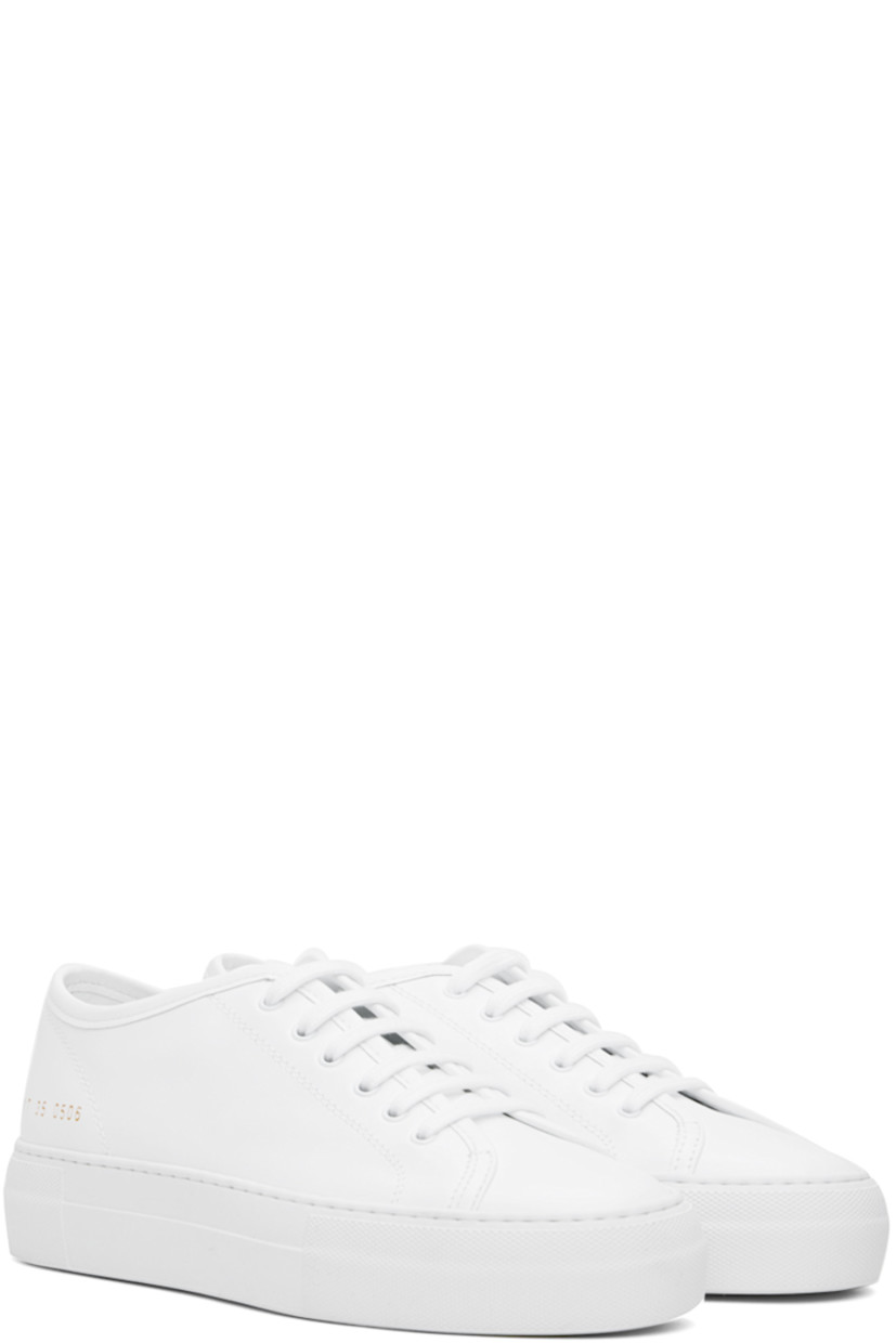 Low-top buffed leather sneakers in white. 

· Lace-up closure
· Signature series stamp at outer side
· Grained leather and suede lining
· Textured rubber platform midsole
· Treaded rubber sole
· Platform: H1.25"

Supplier color: White