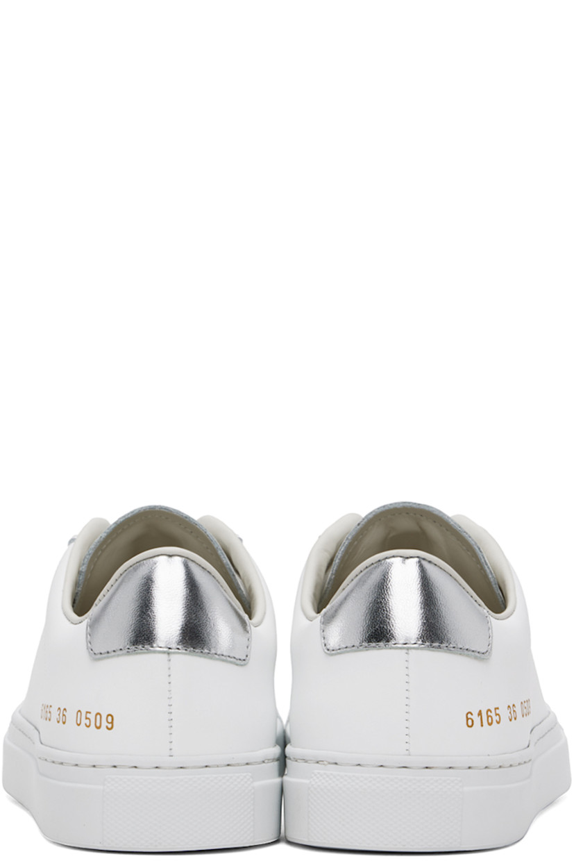 Low-top buffed leather sneakers in white.
 
· Lace-up closure
· Padded tongue and collar
· Gold-tone logo stamp at outer side
· Silver-tone heel tab
· Buffed leather and suede lining
· Treaded rubber sole

Supplier color: White/Silver
