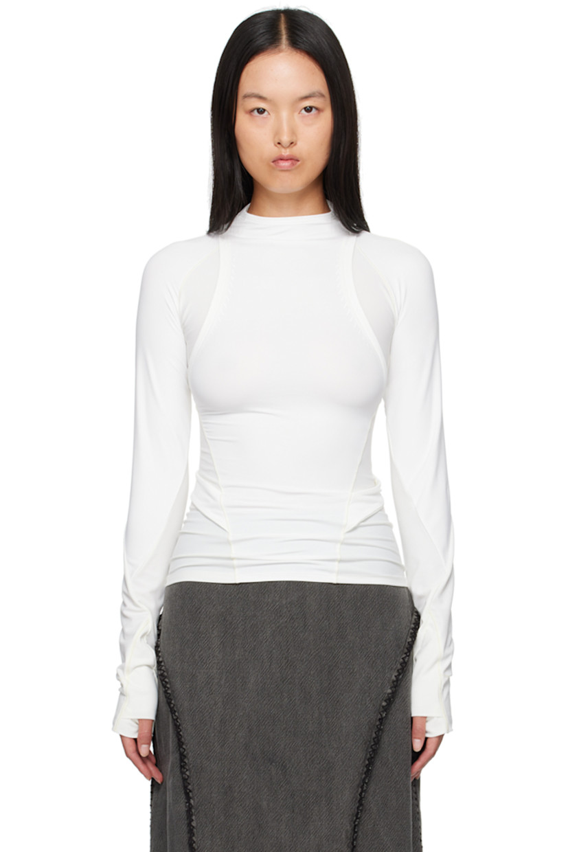 Stretch nylon jersey and ribbed jersey long sleeve T-shirt. 

· Paneled and layered construction
· Mock neck
· Logo-printed integrated straps at waist
· Thumbhole at cuffs
· Zip pockets at back

Supplier color: White