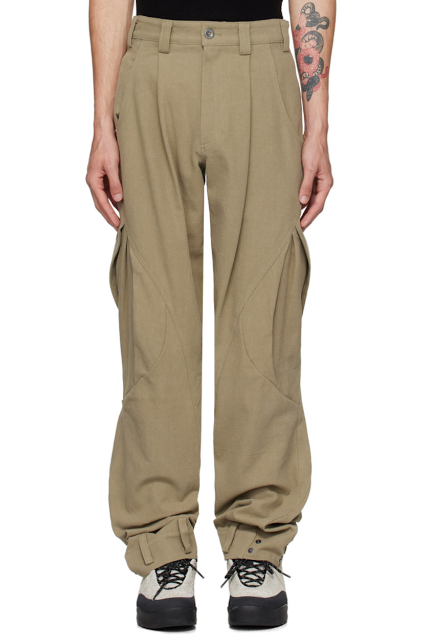 Cotton canvas cargo pants.

· Paneled construction
· Belt loops
· Four-pocket styling
· Zip-fly
· Pleats at front
· Belt loops and press-stud fastening at cuffs
· Pleated flap pockets at curved outseams

Supplier color: Beige