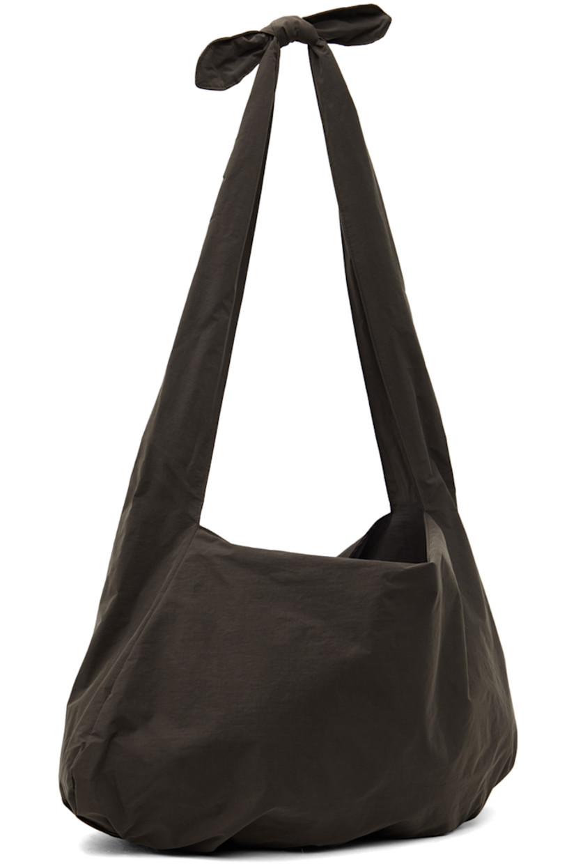 Nylon ripstop shoulder bag in brown. 

· Detachable self-tie strap at twin carry handles
· Logo flag at interior
· Taffeta lining
· Panel at base
· H15" x W21" x D4"

Available exclusively at SSENSE.

Supplier color: Brown