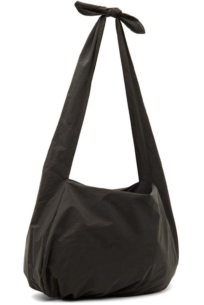 Nylon ripstop shoulder bag in brown. 

· Detachable self-tie strap at twin carry handles
· Logo flag at interior
· Taffeta lining
· Panel at base
· H15" x W21" x D4"

Available exclusively at SSENSE.

Supplier color: Brown