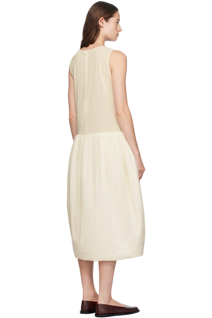 Sheer cotton muslin dress.

· Round neck
· Gathering at waist
· Padded skirt
· Welt pockets
· Zip closure at back
· Partial satin lining

Supplier color: Ivory
