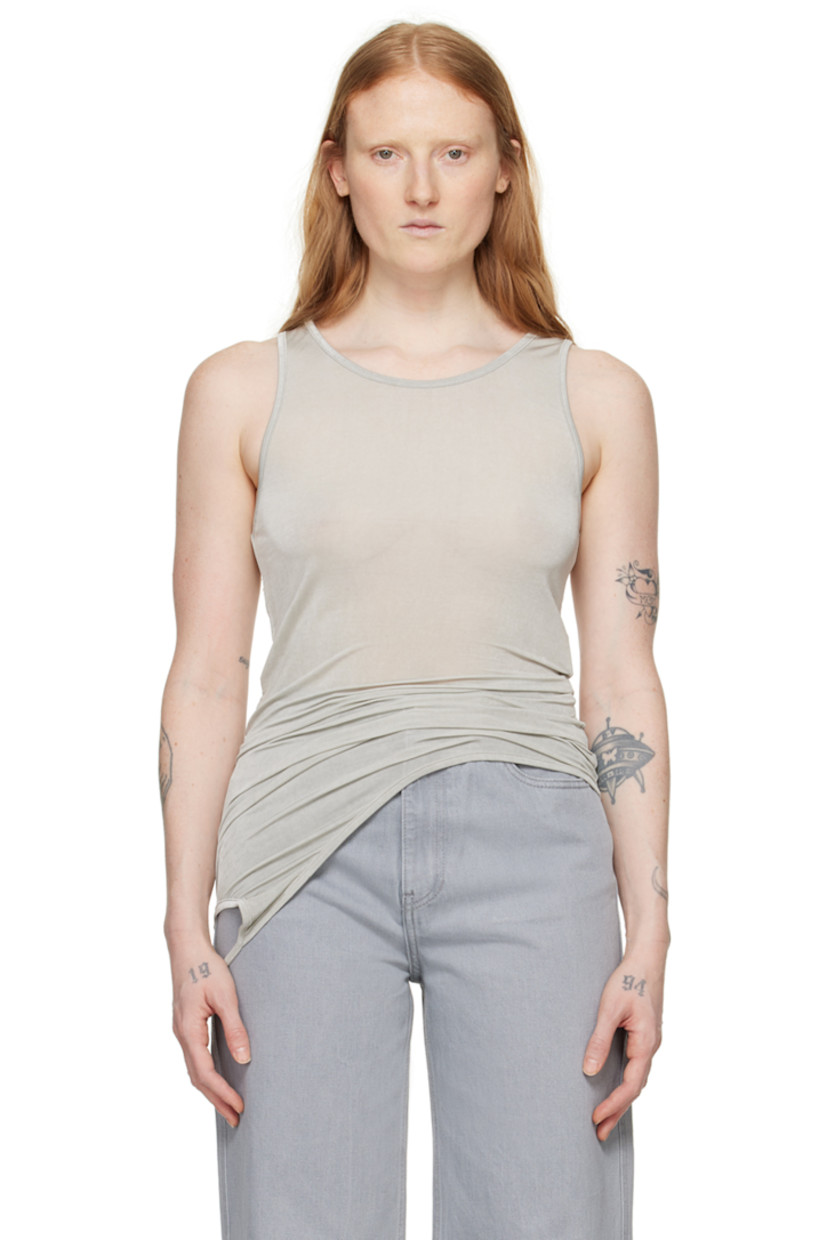 Semi-sheer stretch rayon jersey tank top.

· Crewneck
· Strap at asymmetric hem for alternate styling

Supplier color: Light grey